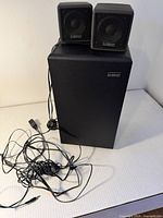 Subwoofer with two satellite speakers and cables