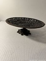 Side view showing filigree bowl and ornate foot