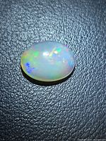 Top view of oval Ethiopian opal showing play-of-colour