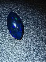 Marquise cabochon loose black opal showing blue and green play of color
