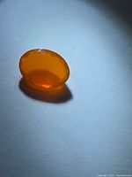 Top view of oval orange faceted fire opal