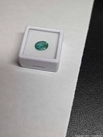 Emerald in gem case top view