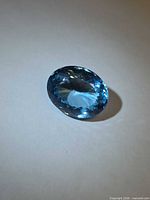 Oval lagoon blue Swiss blue topaz on white background