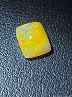 Front view of cushion cabochon opal showing play-of-color