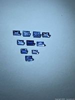 Ten rectangular blue sapphires arranged in a triangle formation