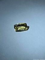 Rectangular cushion-cut golden heliodor on neutral background