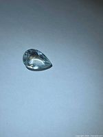 Pear-cut aquamarine gemstone front view on white background