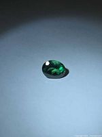 Front angled view of oval green topaz gemstone
