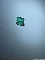 Loose emerald-cut green emerald viewed from top
