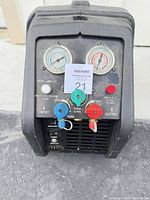 Front view showing dual gauges, valves and control panel of recovery machine