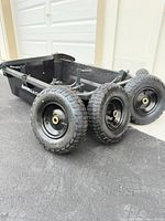 Gorilla Carts dump cart body with three of four pneumatic tires shown