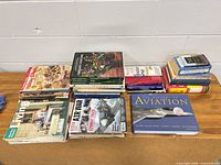 All stacks of books and magazines on wooden table