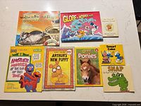 All eight books laid out front covers visible