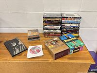 Overall lot showing two DVD stacks, Woodstock set, Benny Hill VHS, loose CDs