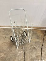Full view of foldable wire hand cart standing upright