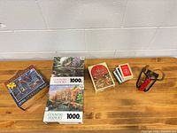 Overview: puzzles, cards, slingshot, kite reel on tabletop