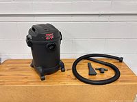 Overall view of Shop-Vac canister, hose and two nozzles