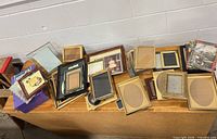Wide view of entire lot of mixed frames on table