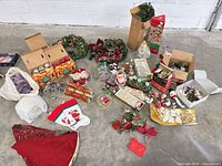 Overview of entire lot showing wreaths, garland, ornaments, tree, crackers, pinecones, stockings, tree skirt