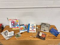 Wide view of all items on table: boxed software, floppy disks, mouse, RAM, manuals