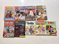 All nine books laid out front covers visible