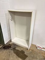 Front view of white shelving unit