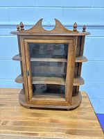 Front view showing glass door, interior shelf and overall design