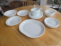 Full lot on table showing plates, bowls, platter, tumblers