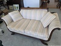 Full view of Duncan Phyfe style sofa with two seat cushions and two throw cushions