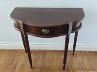 Full view of demilune hallway table showing top, drawer front, legs