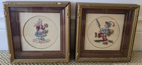 Two square framed roundel cross-stitch figures