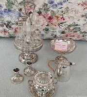 entire lot showing cruet set, hot water pot, gravy bowl, candy dish, candlesticks