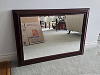 Front view of rectangular wood framed mirror