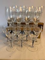 Group view of all crystal stemware sizes on and in front of wooden riser
