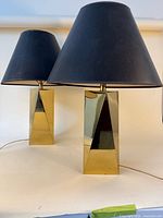 Pair of gold-tone faceted base lamps with black shades