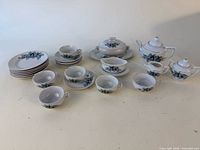 Full view of miniature porcelain tea set showing all components