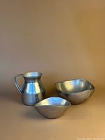 Group shot of stainless pitcher with two aluminum bowls
