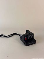Front view of Polaroid Pronto camera showing lens, shutter button and branding