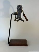 Front view of lever wine opener on stand