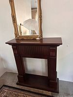 Front view of dark wood fireplace mantel showing full structure