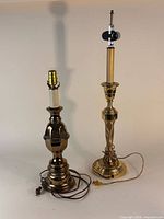 Two brass table lamps, cords visible