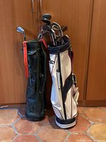Two vintage golf bags filled with clubs side by side