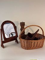 Group showing wicker mirror, two baskets and wood candle holder
