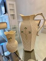 Pitcher and vase front view showing shamrock motif and relief pattern