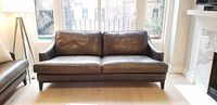 Front view of leather sofa with cushions in place