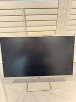 Front view of HP 24f monitor showing screen and slim bezel with stand