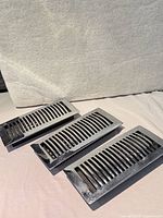 Three chrome-finish vent registers front view