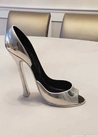 Right side view of chrome stiletto shoe form