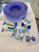 Bowl and scattered glass candies on paper towel