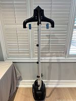 Full view of steamer showing base, pole, hose and hanger